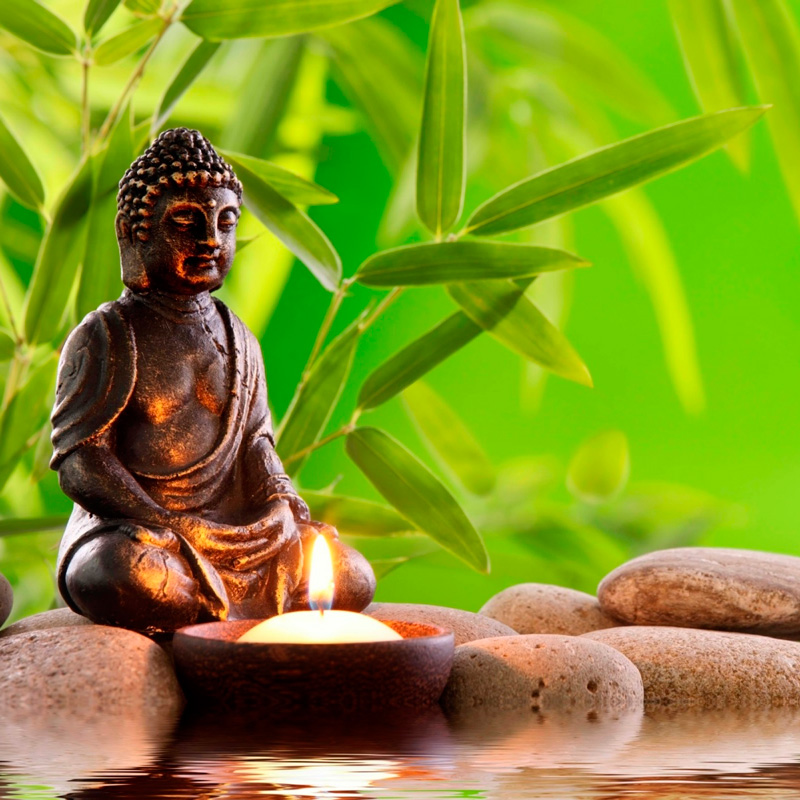 Buddha-statue-stones-water-bamboo-leaves-candle